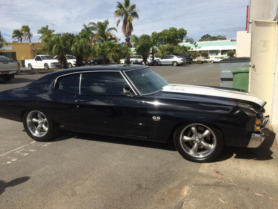Black and white Chevrolet Chevelle parked outdoors.