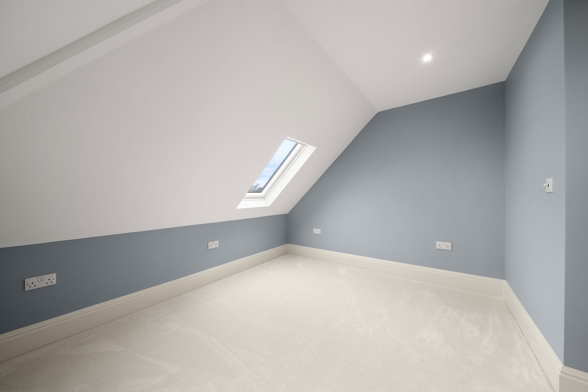 An empty room with a skylight in the ceiling
