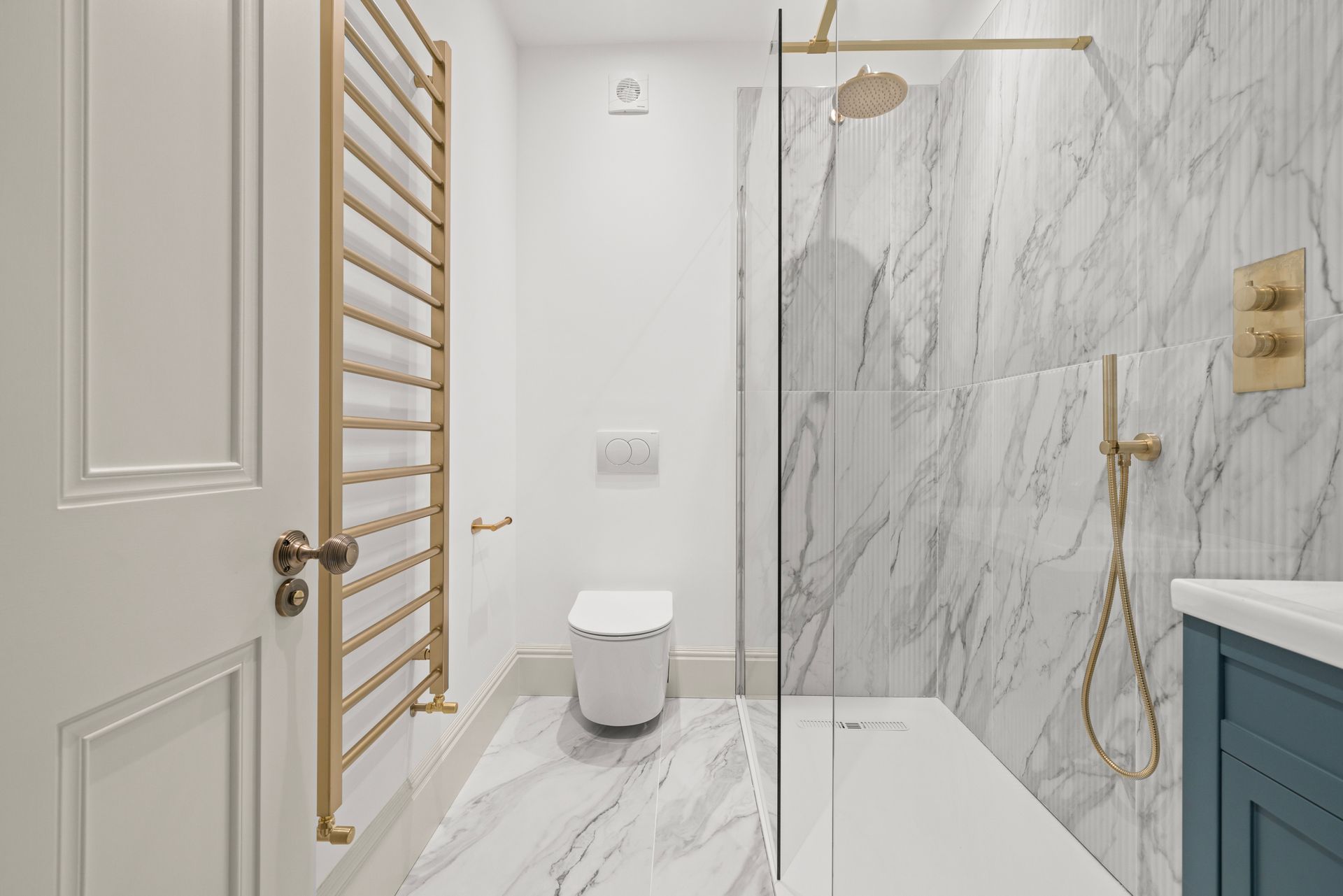 A bathroom with a walk in shower and a toilet.