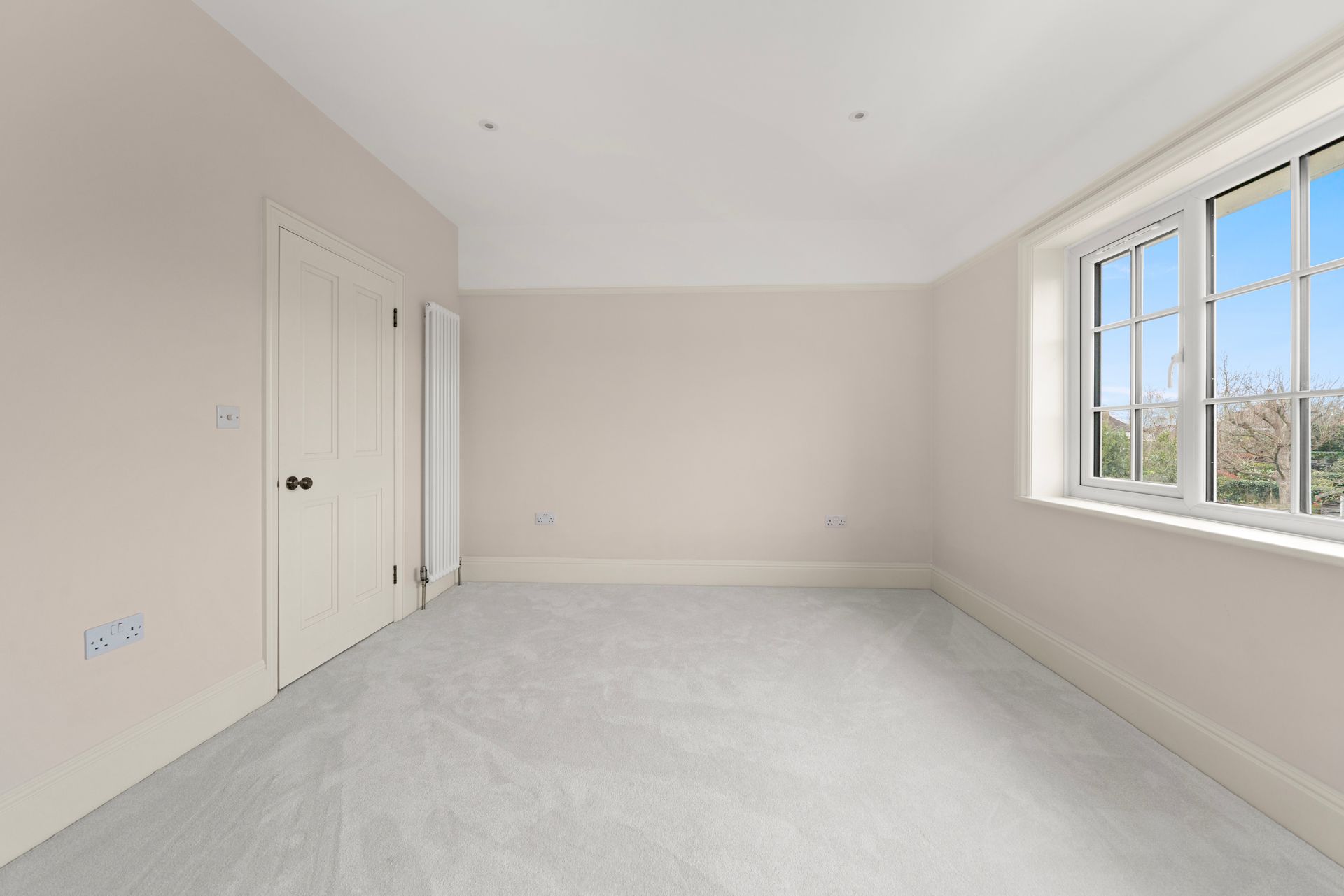 An empty room with white walls and a window.
