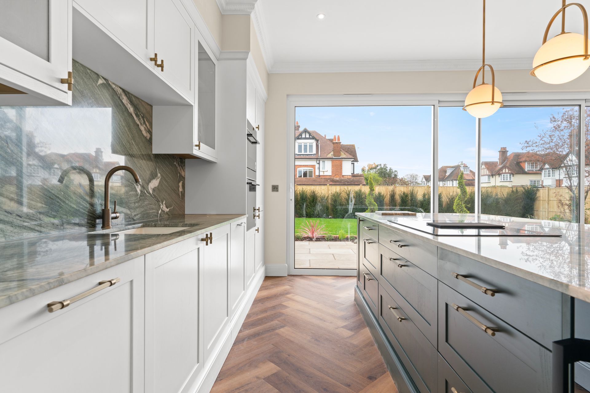A kitchen with a large island and sliding glass doors.