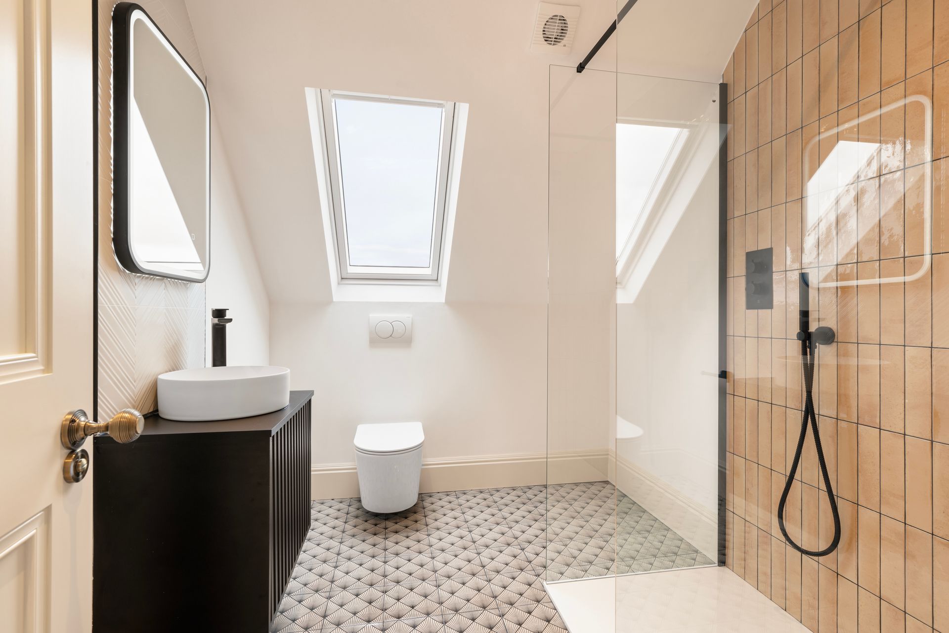 A bathroom with a walk in shower , toilet , sink and mirror.