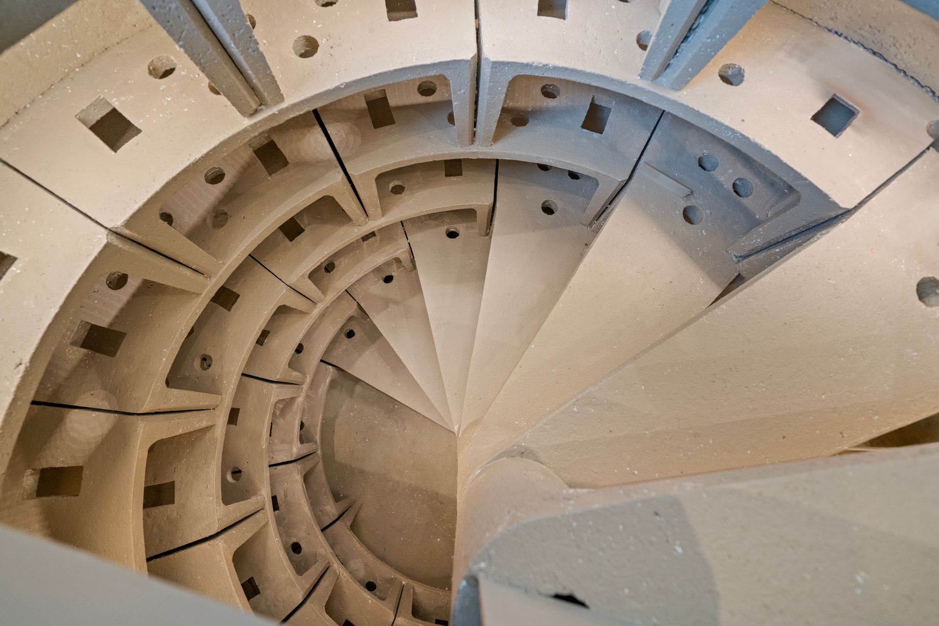 A close up of a spiral staircase in a building.