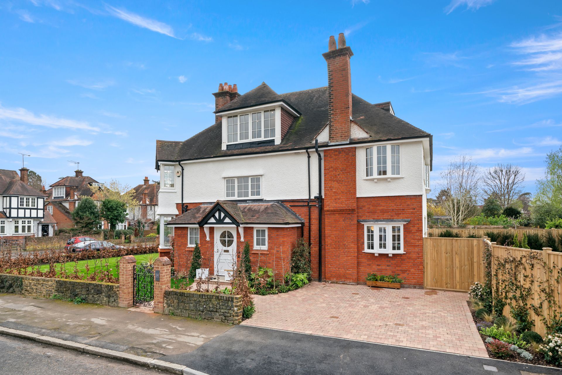 A large brick house with a driveway in front of it.