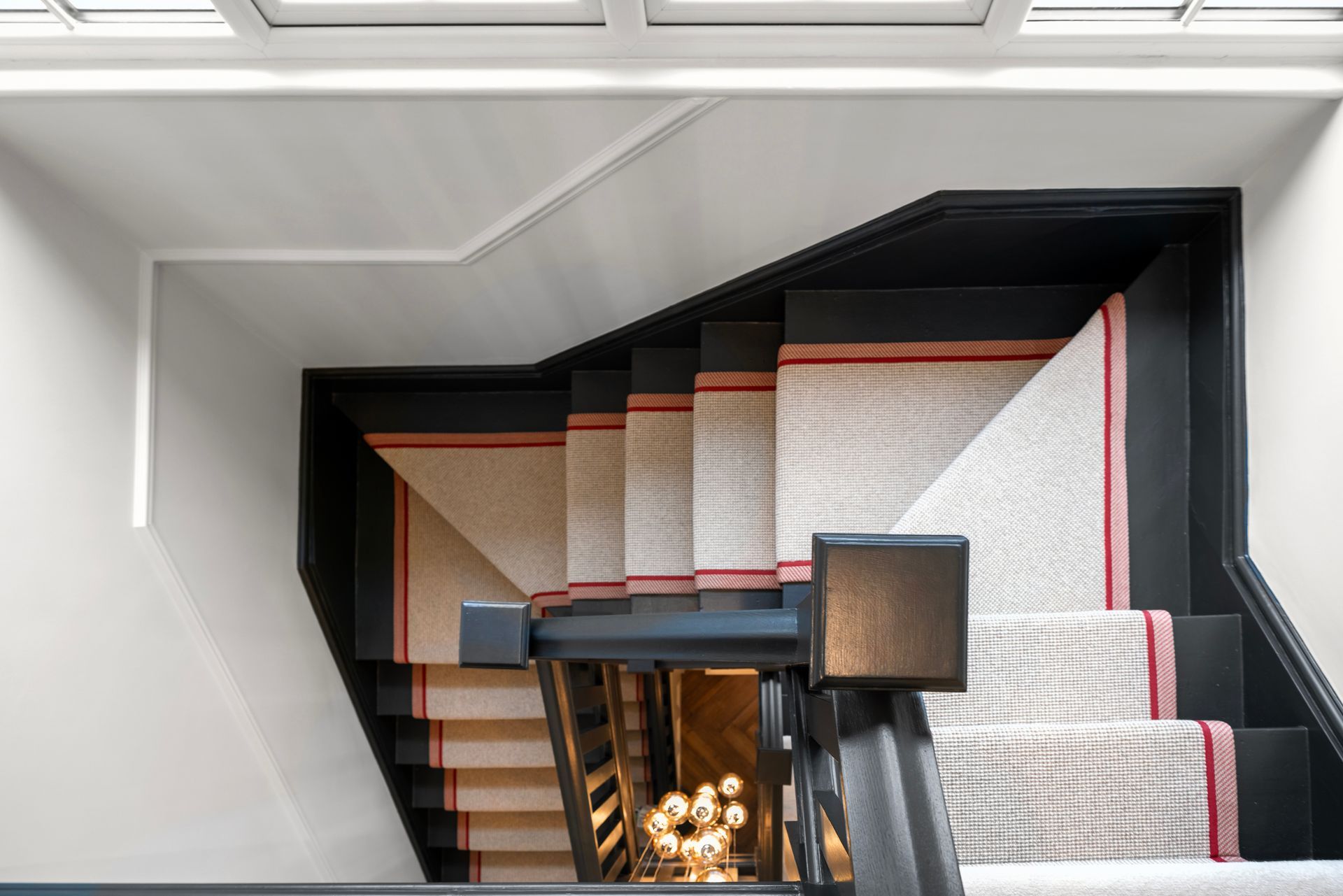 A black and white staircase with a red stripe on the bottom.