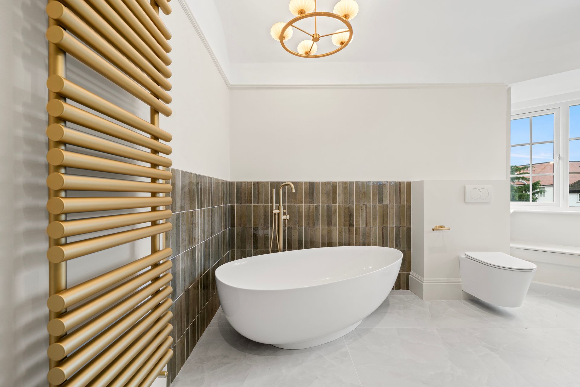 A bathroom with a bathtub , toilet , and towel rack.