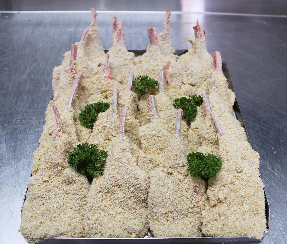 A Tray of Breaded Lamb With Parsley on Top — Nambour Heights Butchery in Nambour, QLD
