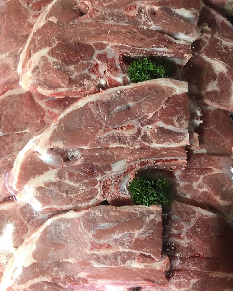 A Pile of Raw Lamb Chops With Parsley on Top — Nambour Heights Butchery in Nambour, QLD