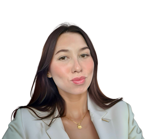 Founder. Woman with long brown hair, wearing a white blazer and gold necklace, pouting her lips.