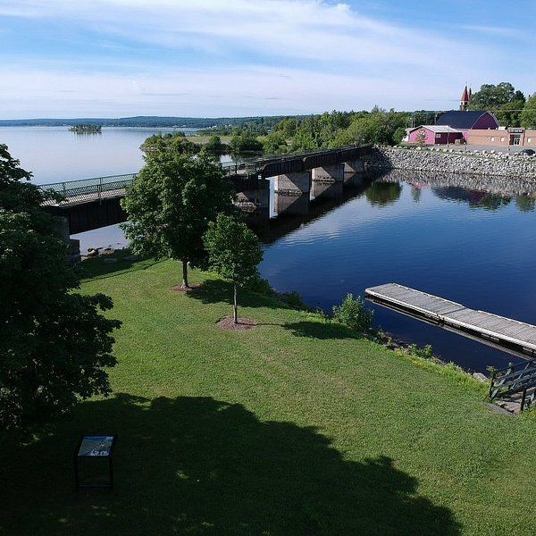 Three silver vehicles parked in front of Carlson Funeral Home on a sunny day.