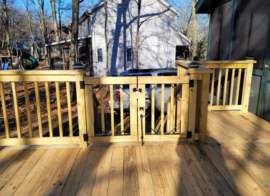 Wooden deck with gate and railing.
