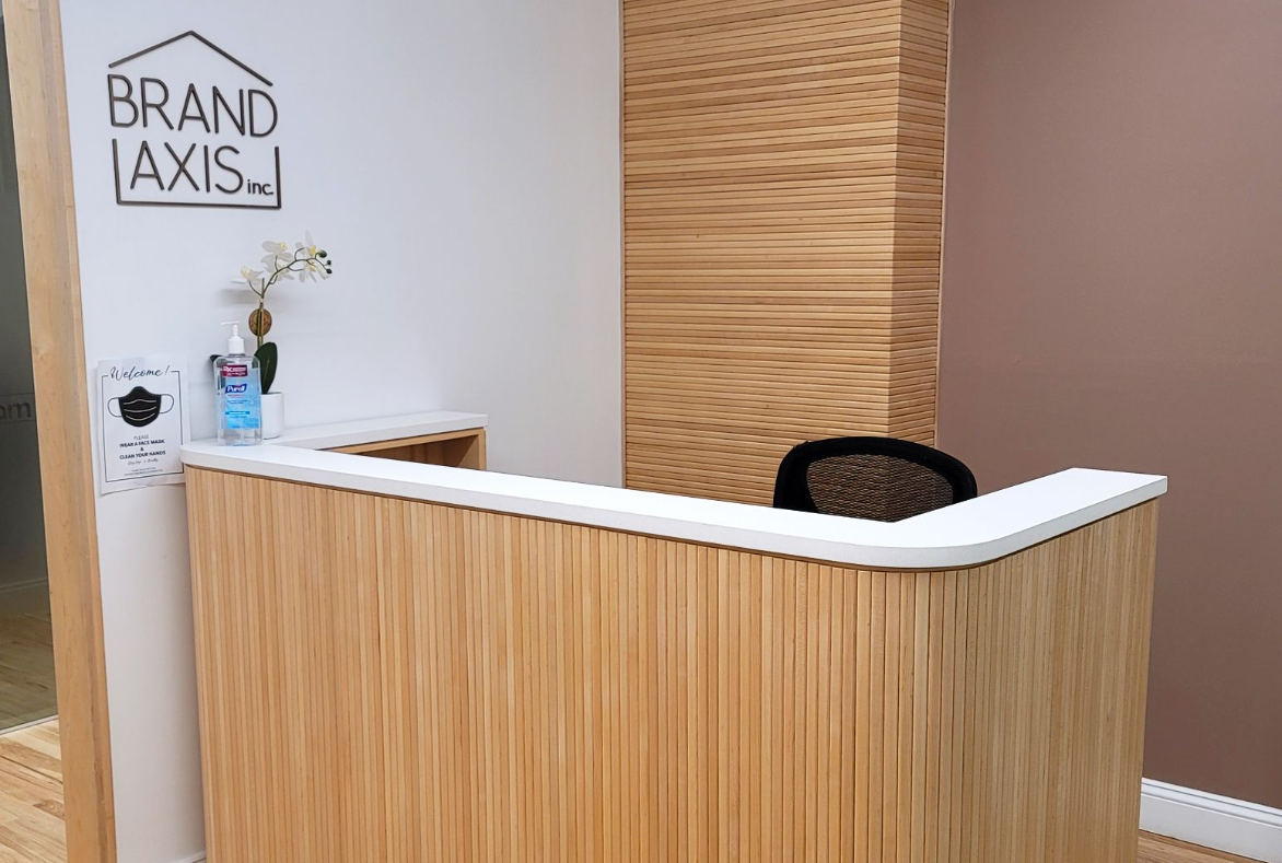 Reception desk with wooden paneling, white countertop, and 