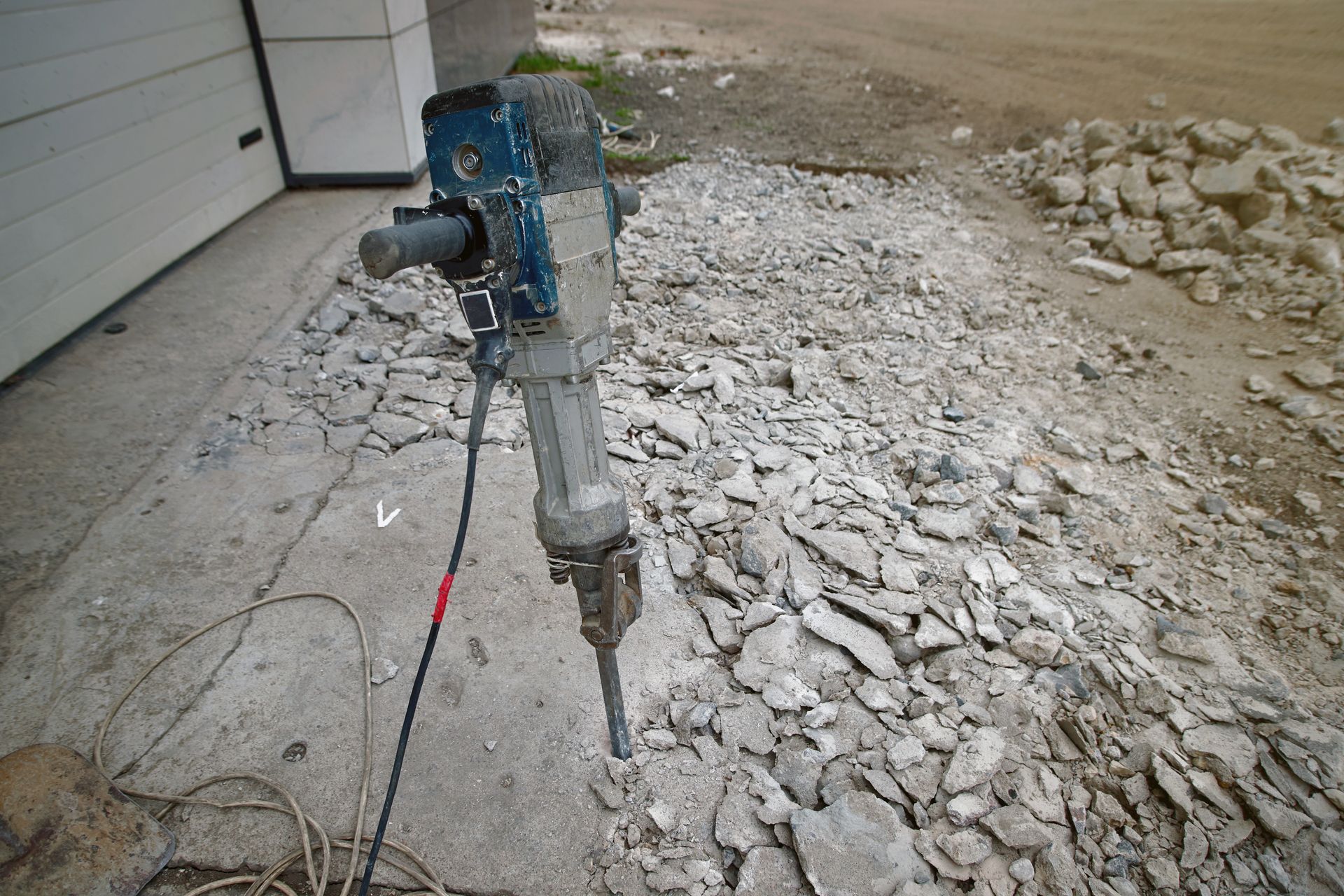 A hammer is sitting on top of a pile of rocks.