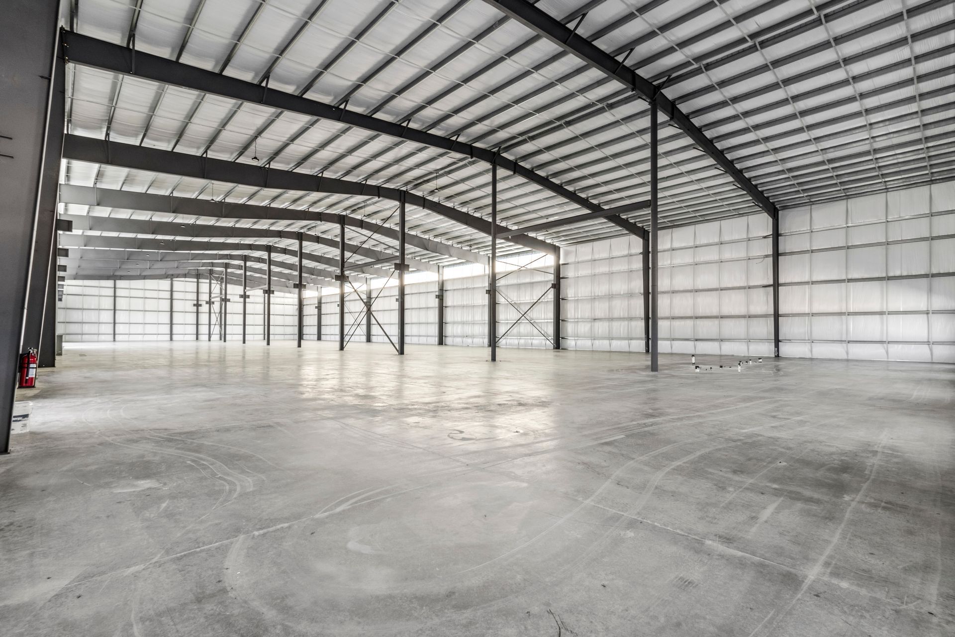 A large empty warehouse with a concrete floor