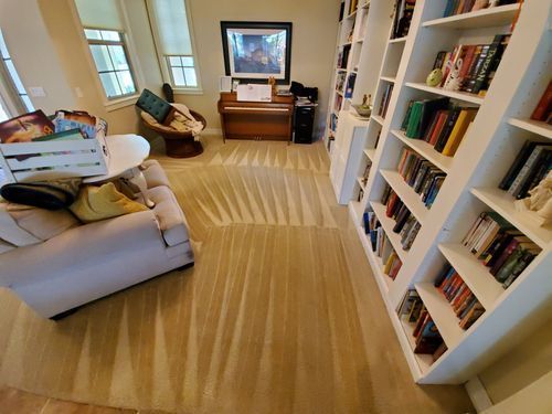 Professional rug cleaning with deep steam extraction in residential Mesa, AZ reading room