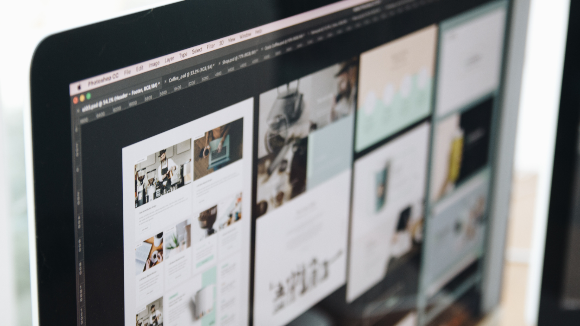 A computer screen displaying a grid of web design layouts, with muted tones and a modern aesthetic.