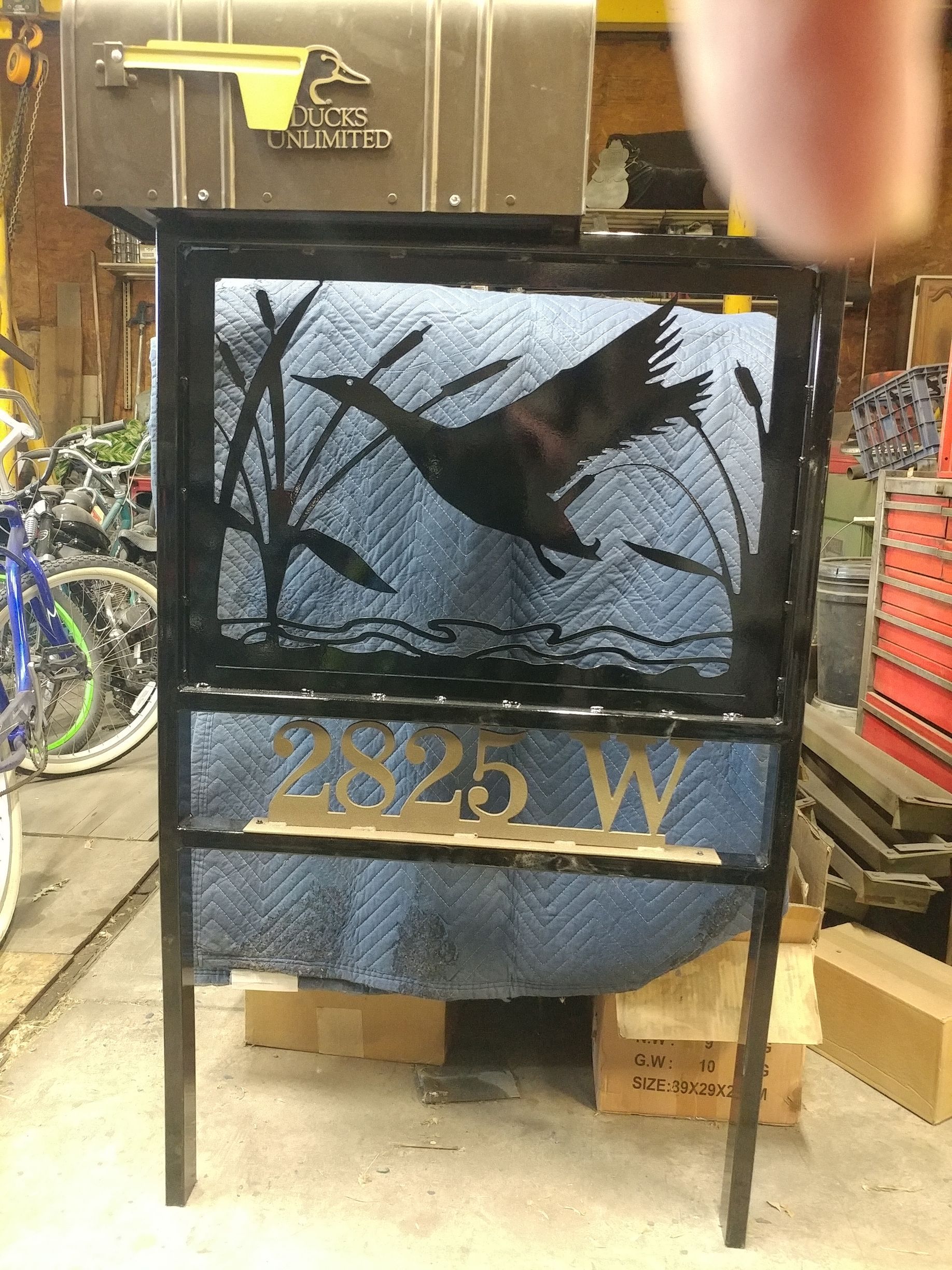 Metal mailbox with duck silhouette, address 