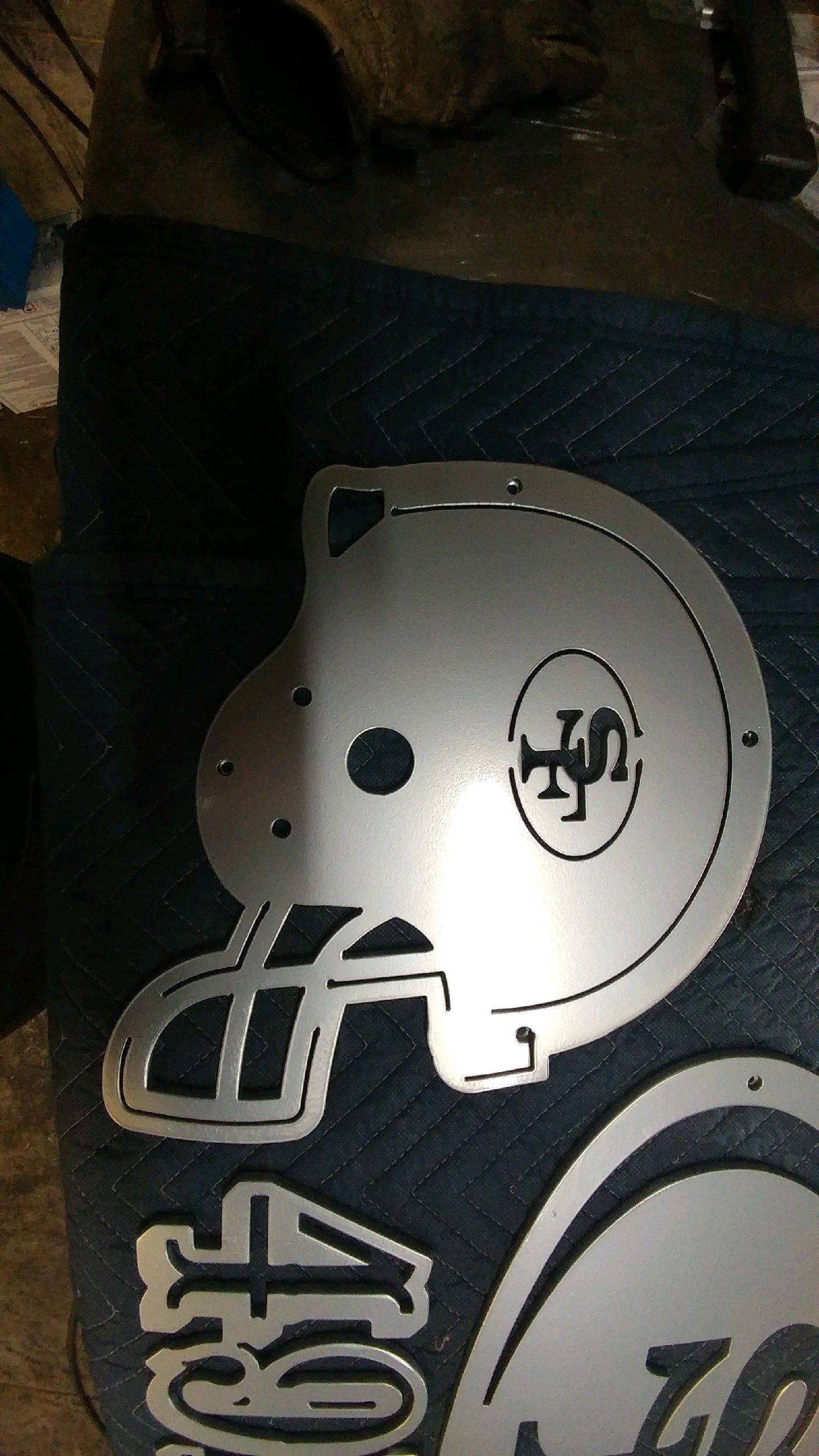 Silver metal 49ers football helmet cutout with the team logo.