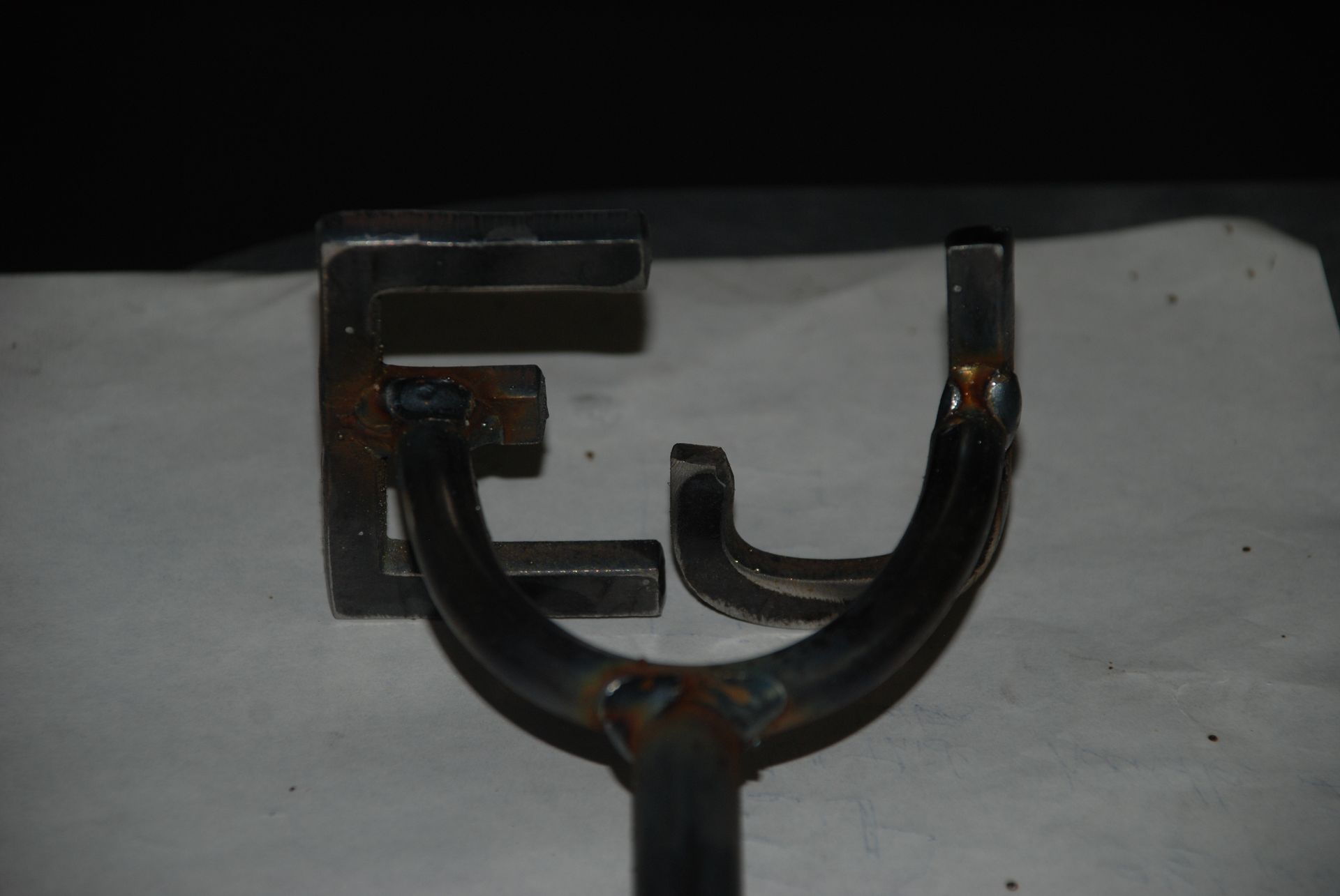 Metal brand in the shape of the letters 