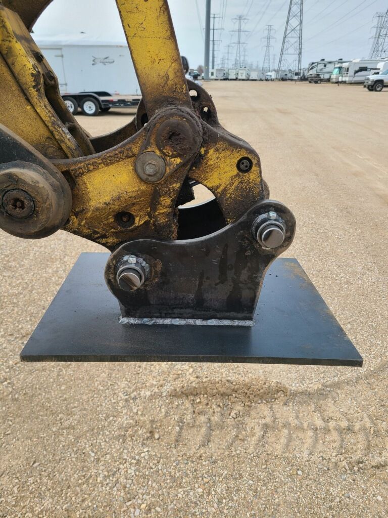 Construction worker with safety harness installing metal frame of a building.