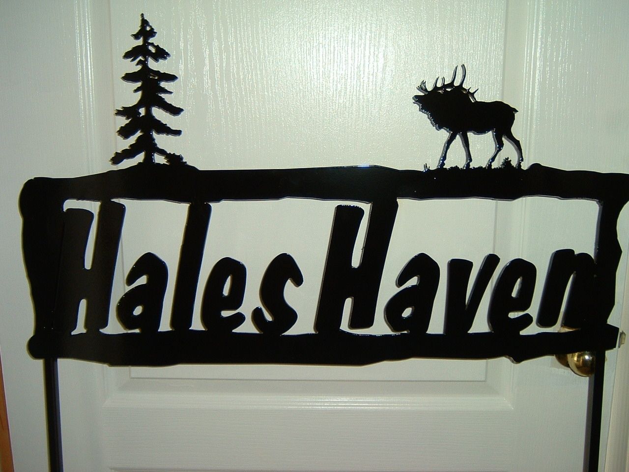 Black metal sign: 