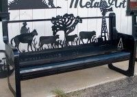 Black metal art bench with a cowboy, cattle, and windmill silhouette.