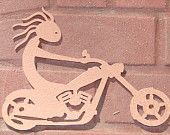Wooden silhouette of a Kokopelli figure riding a motorcycle.