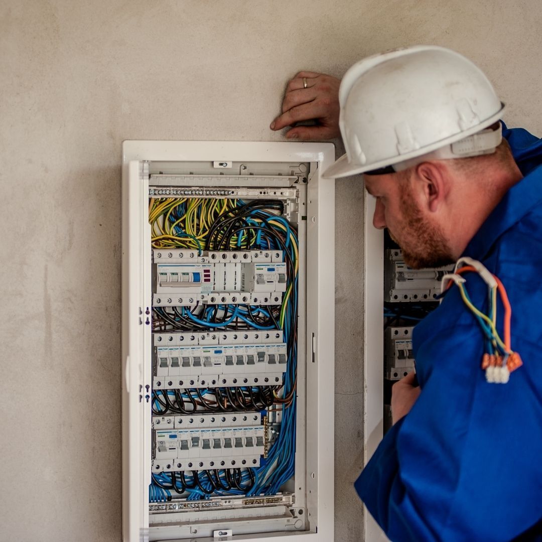 electrician working on electrical panel