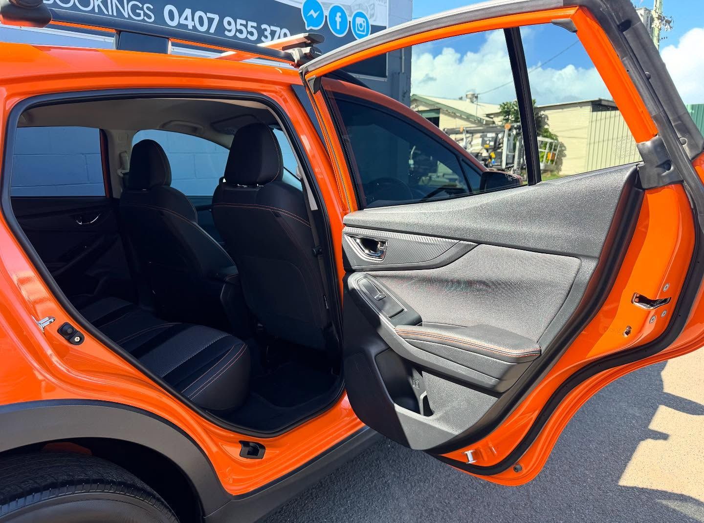 Orange Subaru Car Interior With Open Back Door, Showing Seats — Oliver's Hand Car Wash in Norville, QLD