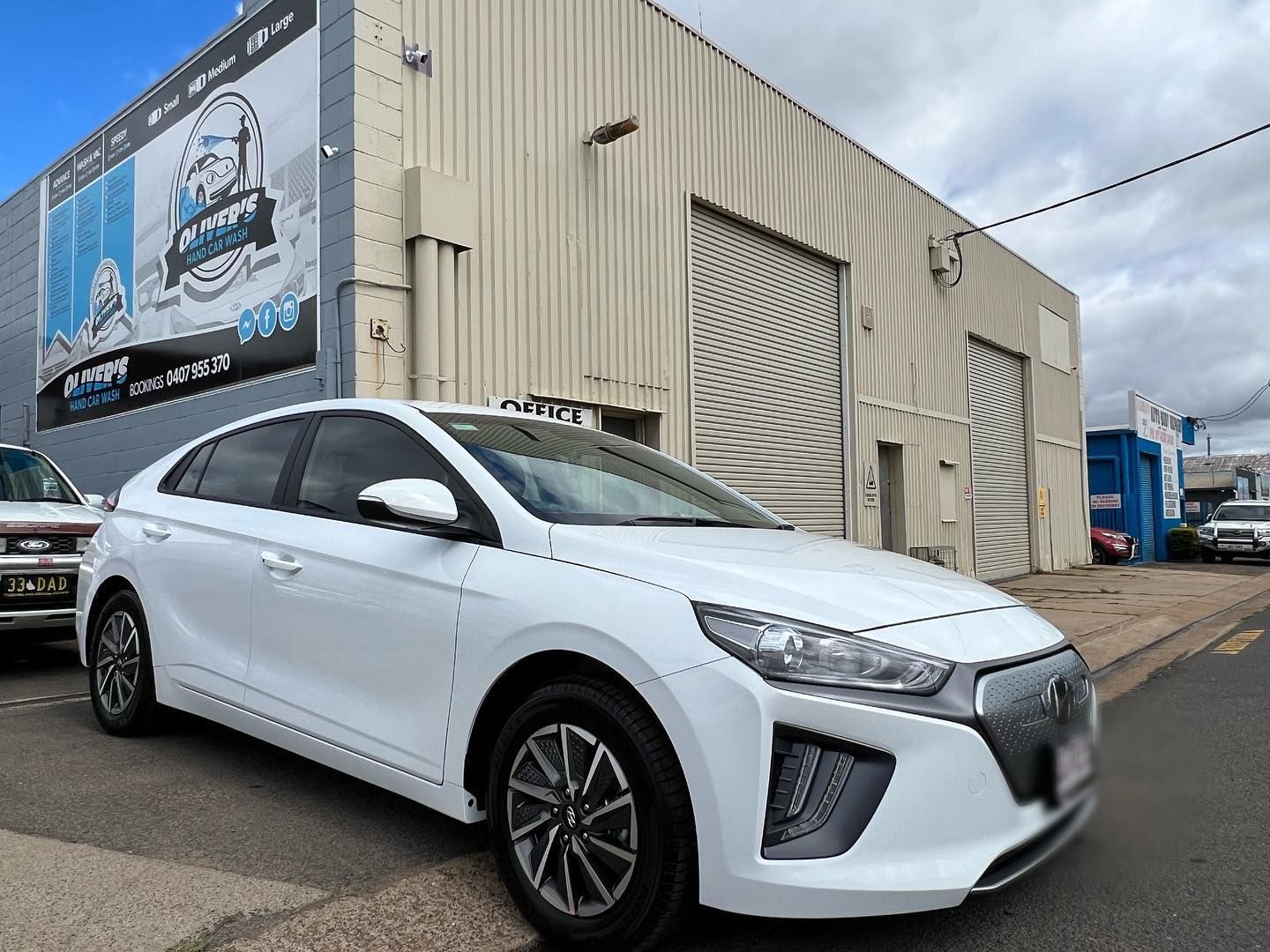 White Hyundai Electric Car Parked in Front of a Building — Oliver's Hand Car Wash in Norville, QLD