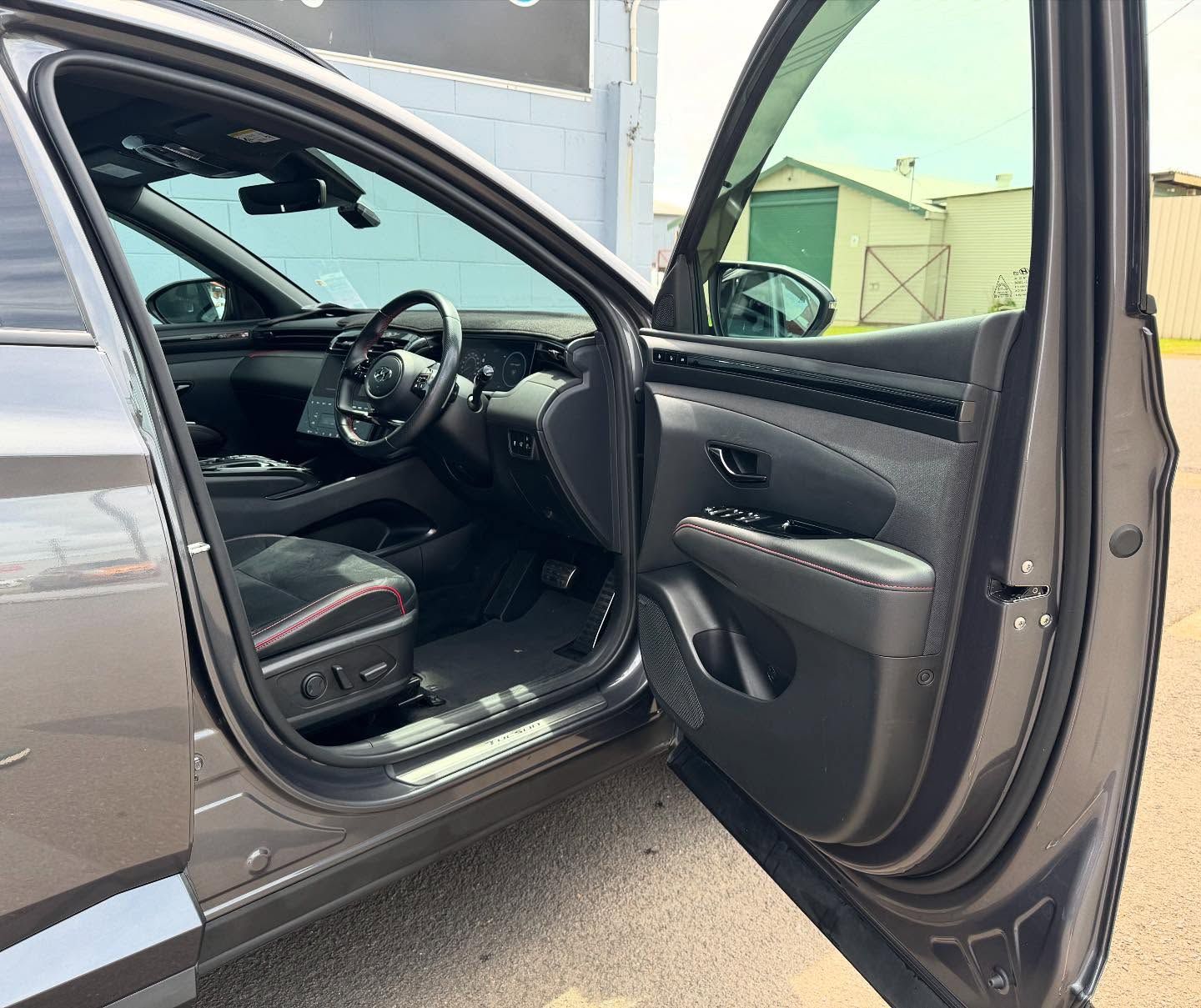 Gray Car Interior With Open Door; Steering Wheel, Seats, and Dashboard Are Visible — Oliver's Hand Car Wash in Norville, QLD