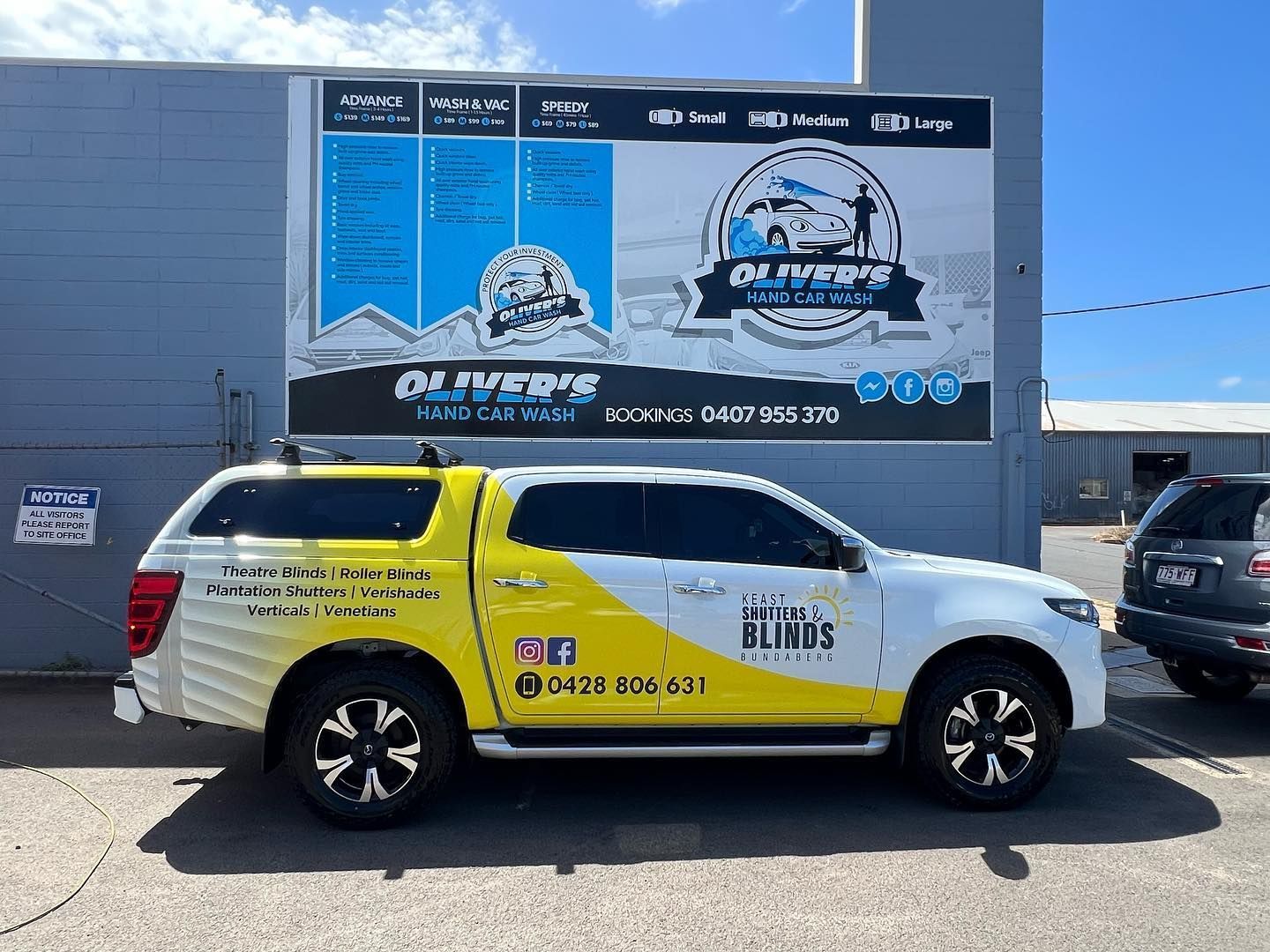 A white and yellow pickup truck with company logos parked in front of a building with a large sign. — Oliver's Hand Car Wash in Norville, QLD