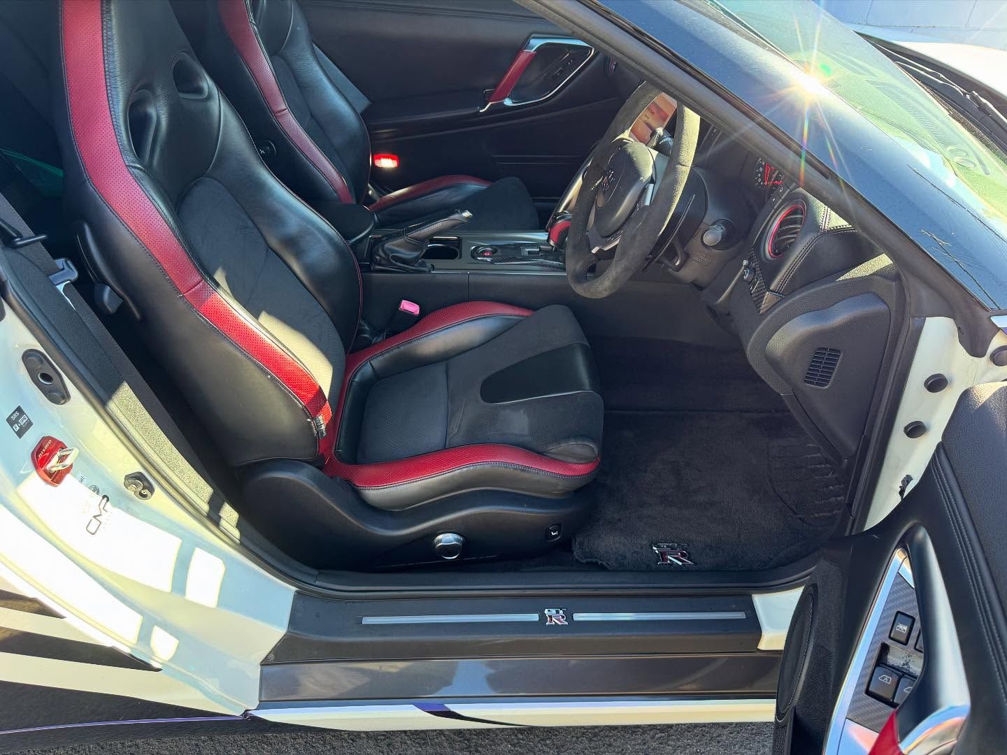 Interior View of a White Sports Car With Black and Red Racing Seats — Oliver's Hand Car Wash in Norville, QLD