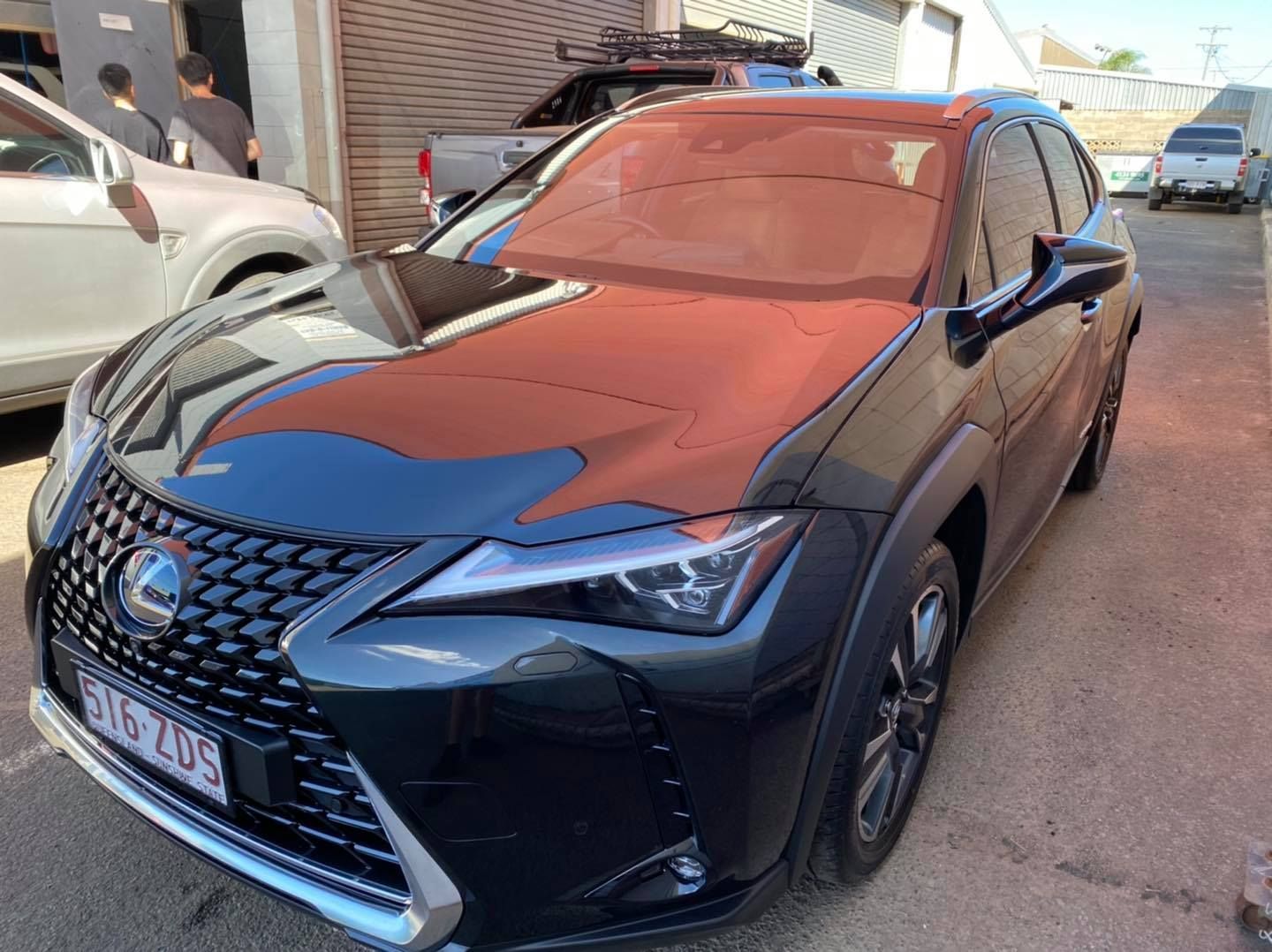 Dark Gray Lexus Ux Suv Parked Outside a Garage, With a Prominent Front Grill — Oliver's Hand Car Wash in Norville, QLD