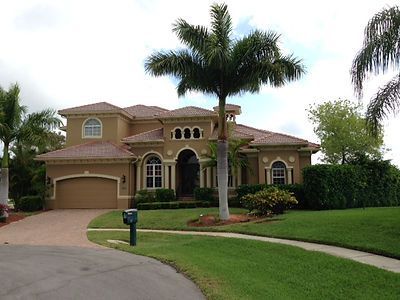 A large house with a palm tree in front of it