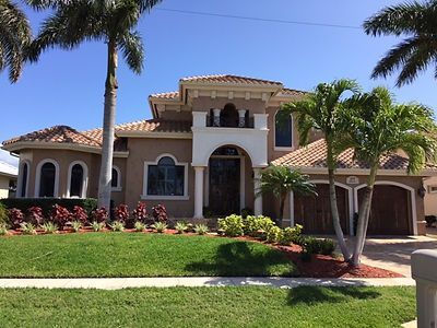 A large house with palm trees in front of it