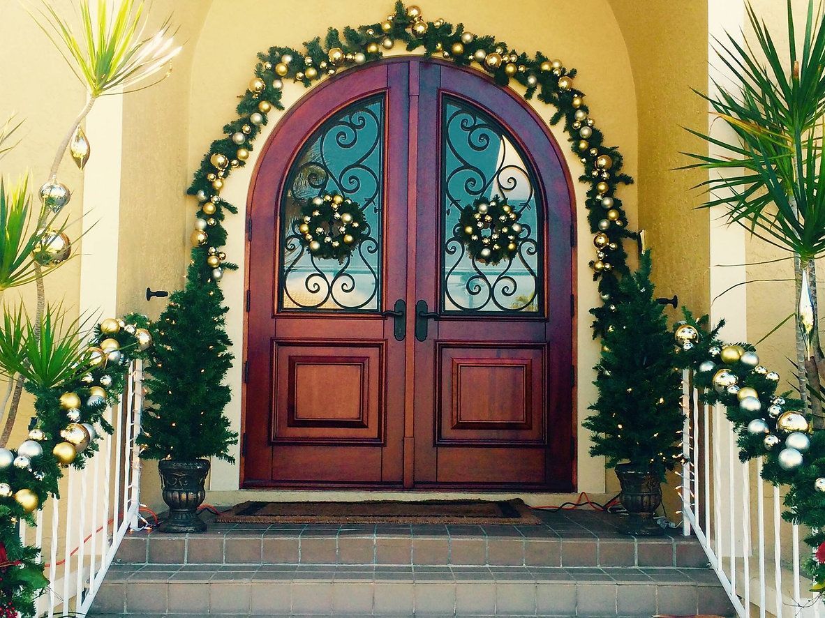 The front door of a house is decorated for christmas