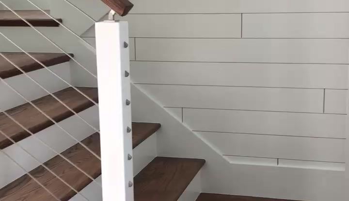 A staircase with wooden steps and a white railing.