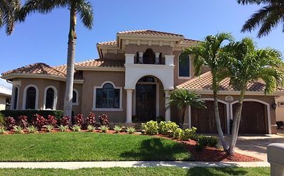 A large house with a palm tree in front of it