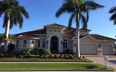 A large house with palm trees in front of it