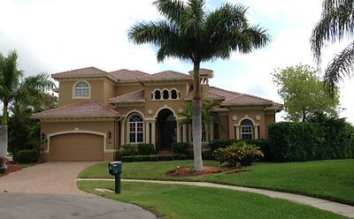 A large house with a palm tree in front of it