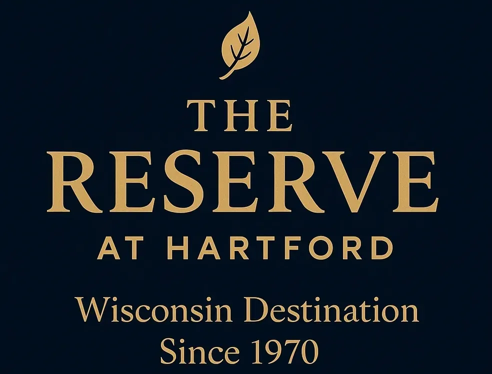 The Reserve at Hartford logo: gold text on a navy blue background, with a leaf icon above the words.