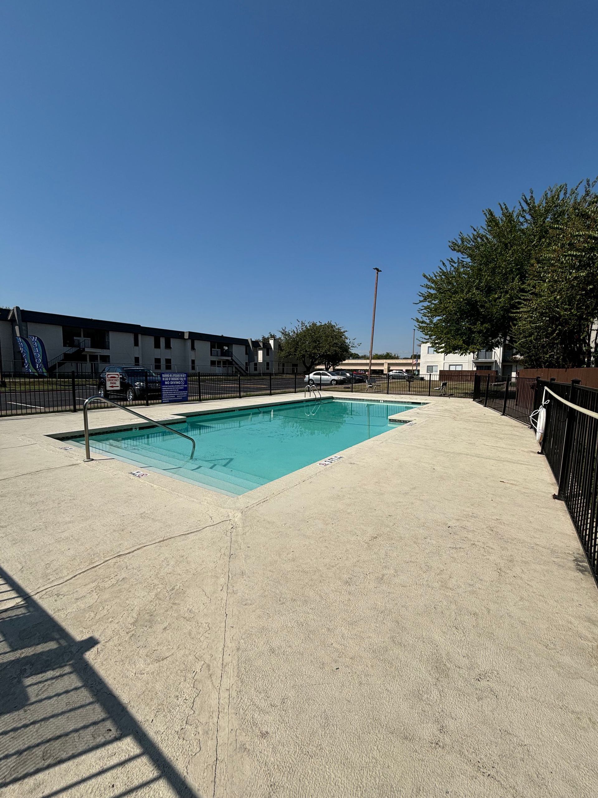 A large swimming pool with a fence around it
