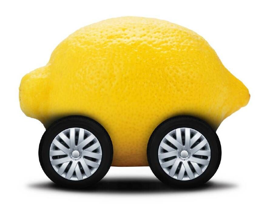 a lemon with wheels on a white background