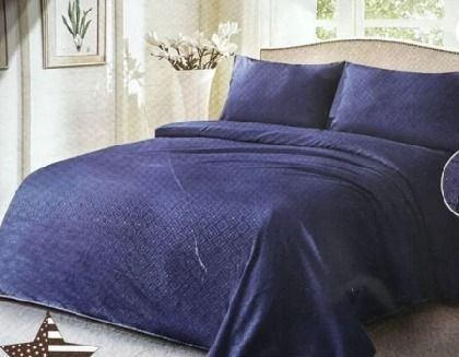 Sábanas de color azul marino sobre una cama en una habitación con una ventana y un cuadro en la pared.