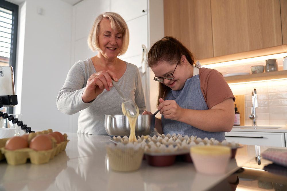 A Woman and a Girl Are Preparing Food in a Kitchen — Better Access Support Services In Stanthorpe, QLD