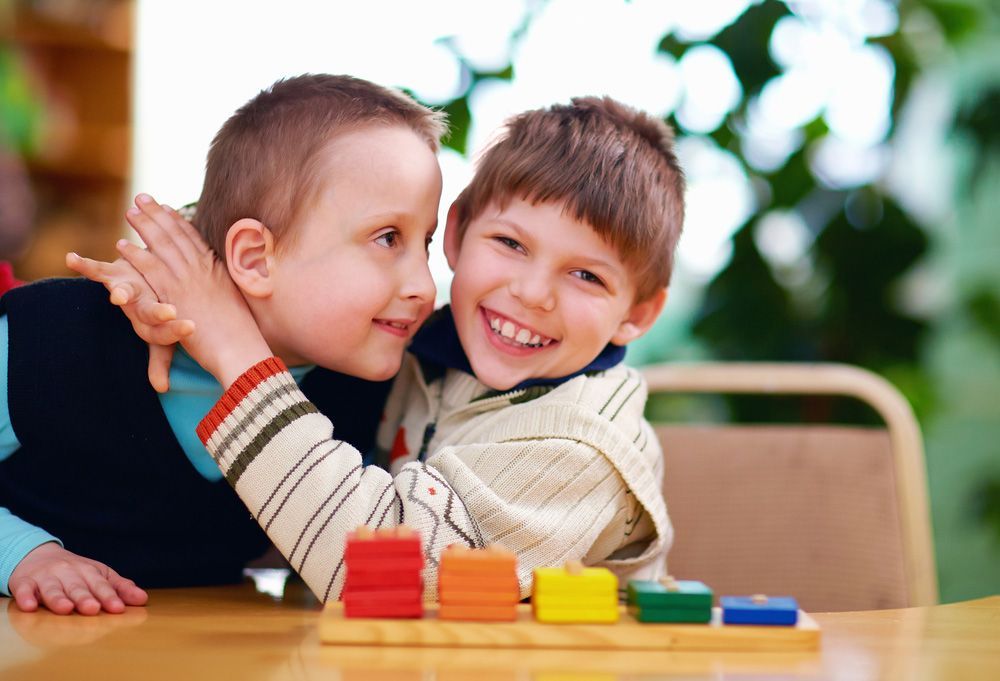 Two Boys Sitting At A Table
