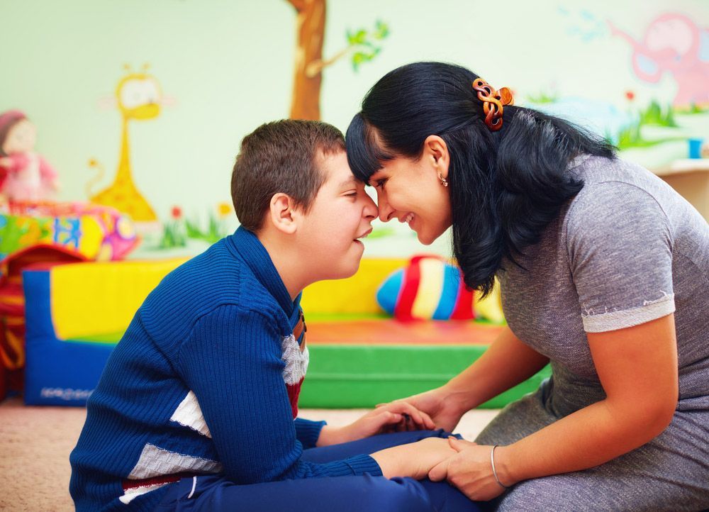 Woman And Boy Sitting On Floor