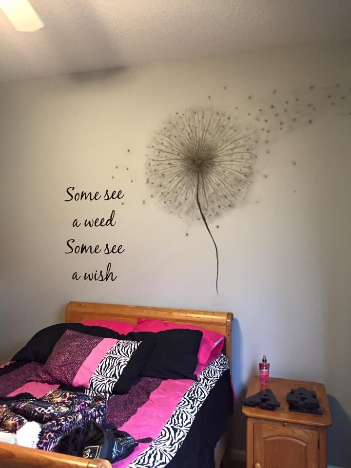 Bedroom with dandelion wall decal and bed with pink and black bedding.