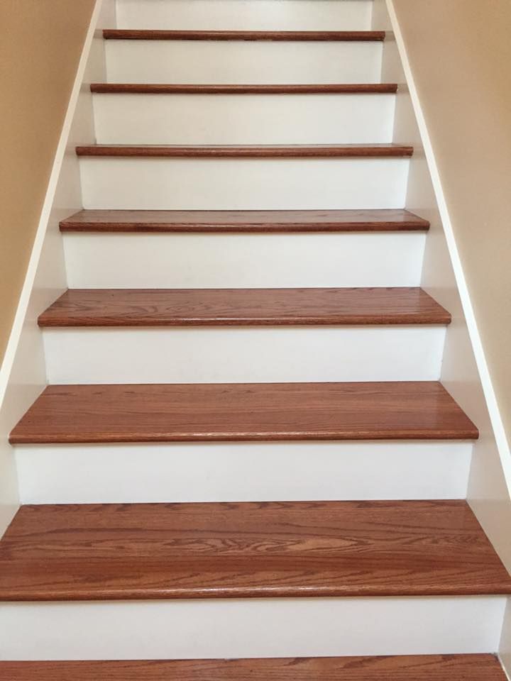 Wooden staircase with white risers and brown treads.